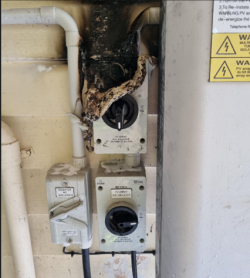 A DC isolator that has been damaged by a fire. 