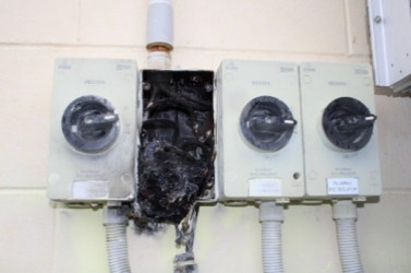 A DC isolator that has been damaged by a fire. 