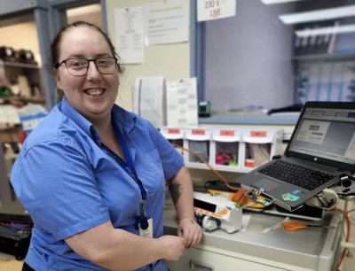 Ashlea with her laptop in her laboratory.